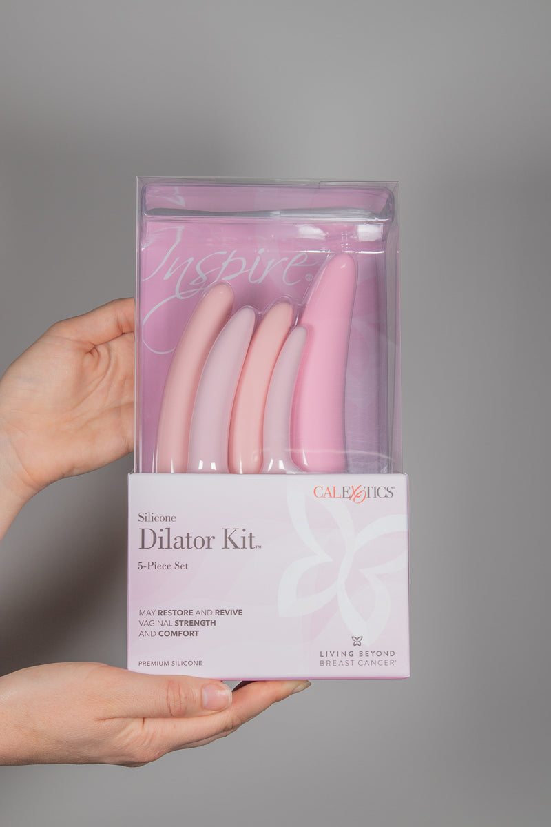 Hands holding the CalExotics 5 piece dilator kit in packaging