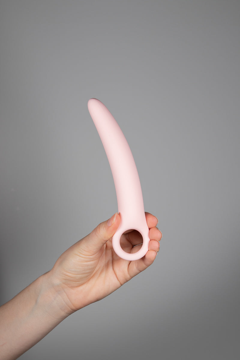 A Hand holding one of the largest dilator upright