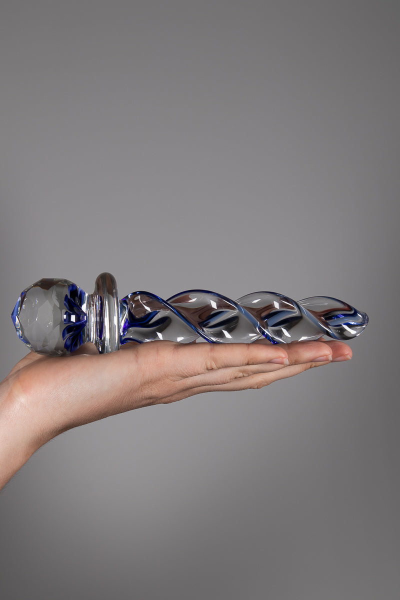 Faceted implosion dildo held flat in palm of hand