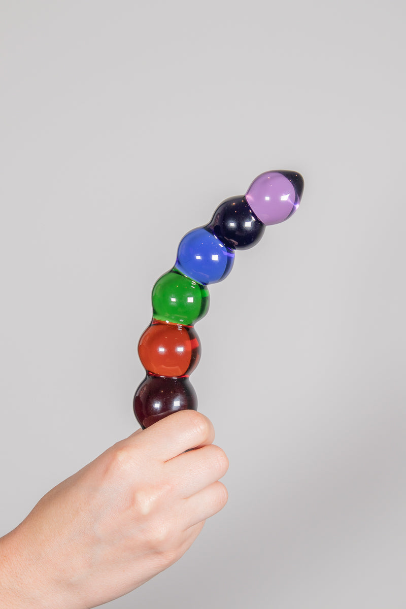 Rainbow Bubble Dildo gripped in fist of hand